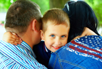 Parents hugging young boy