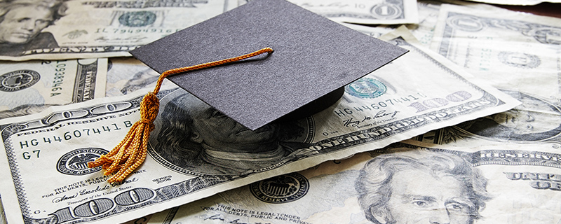 Graduation cap and $100 bills