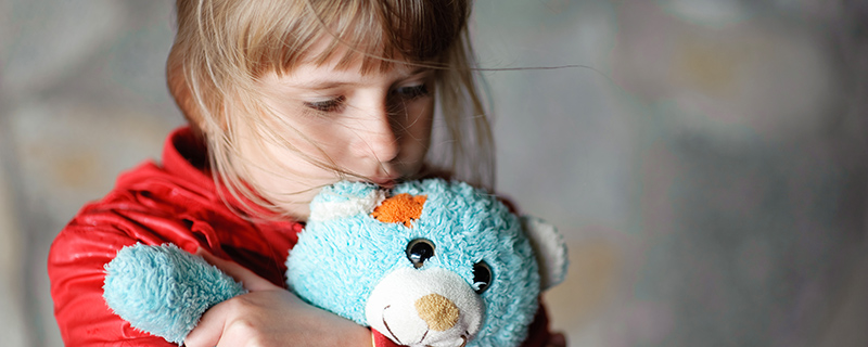 Little girl holding teddy bear