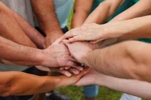 Stacking hands showing teamwork (Shutterstock)