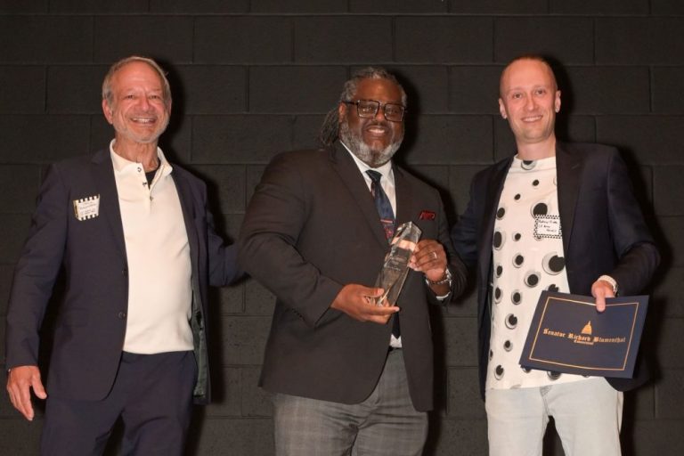 Photo of Andre Rochester receiving award.