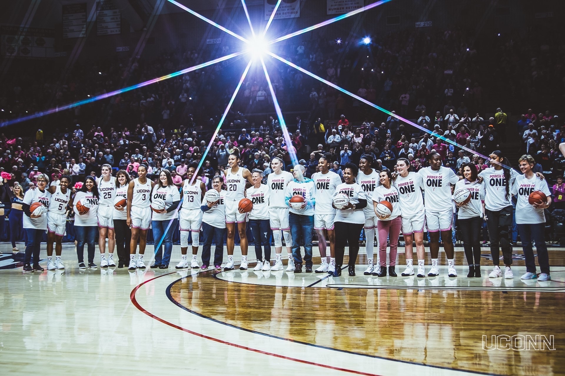 girls.game_2002 UConn women's basketball team on court with UConn Health breast cancer care team and patients