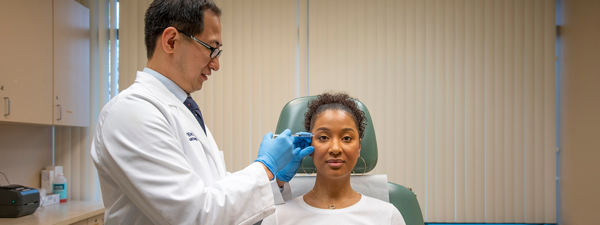 Dr. Hao Feng injects a patient with a filler