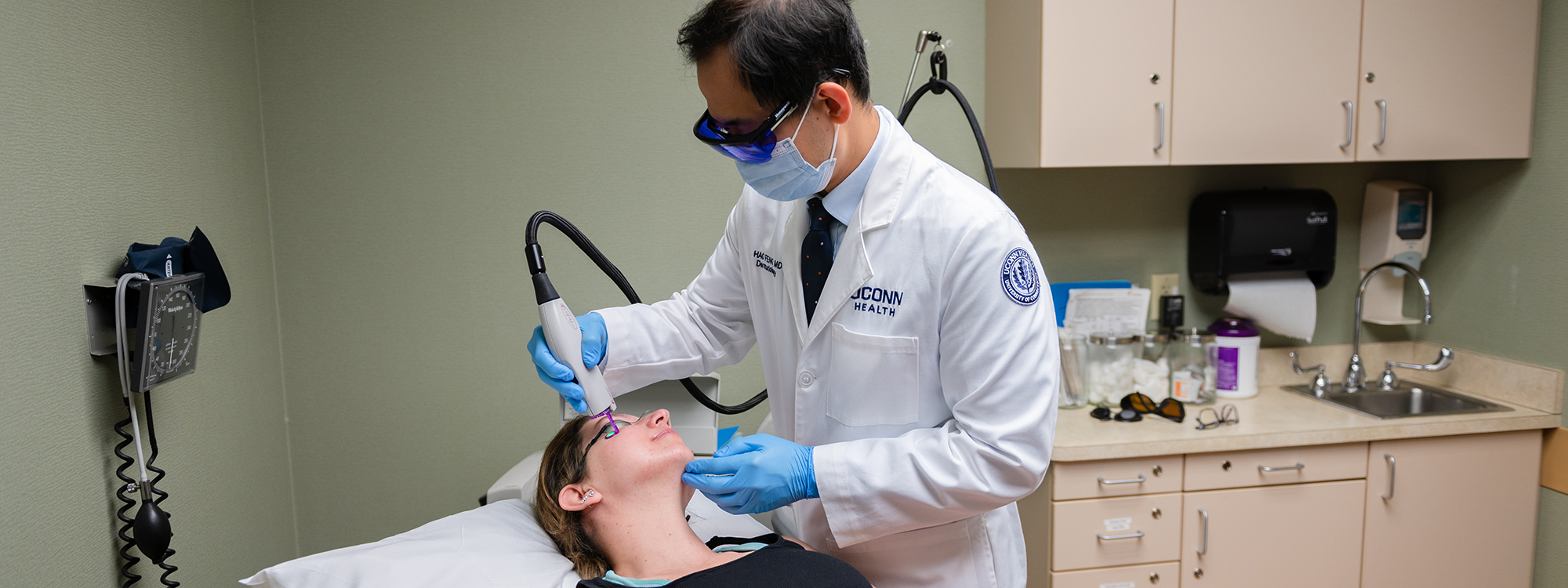 Hao Feng, M.D., MHS, FAAD, performs a cosmetic laser procedure on a patient