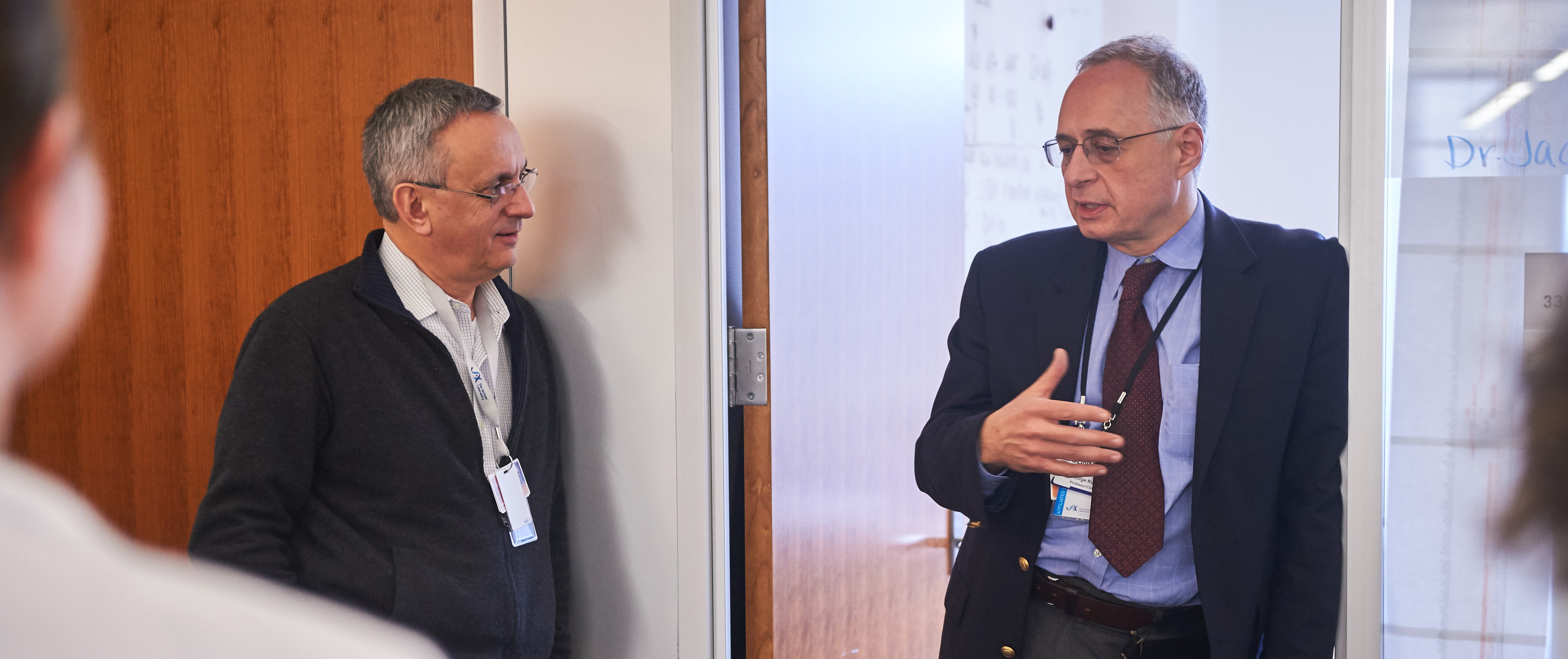 Jacques Banchereau, left, and Dr. George Kuchel, director of the UConn Center on Aging speak to visitors.