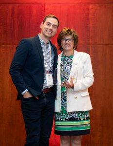 Madison Doolittle receiving award from ASBMR President Laura Calvi