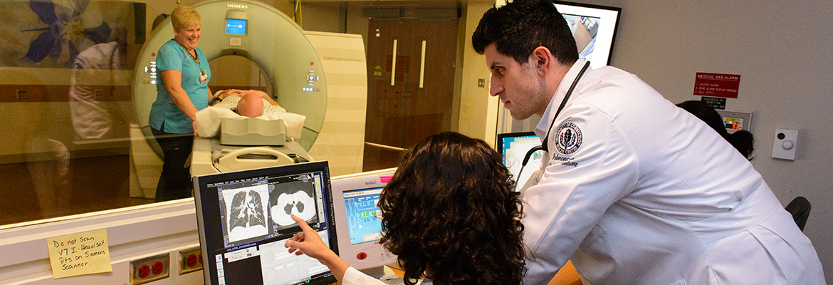 Dr. Omar Ibrahim looking over a low dose CT scan