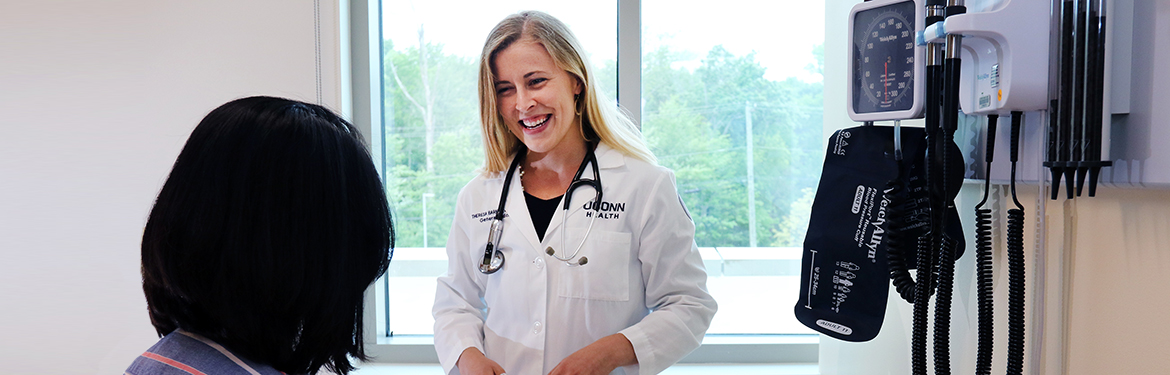 Britta L. Shute, FNP-BC, talking to a patient