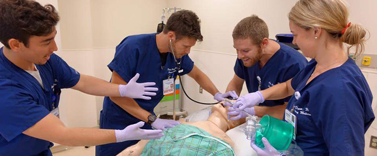 Emergency Medicine residents practicing on a patient manikin