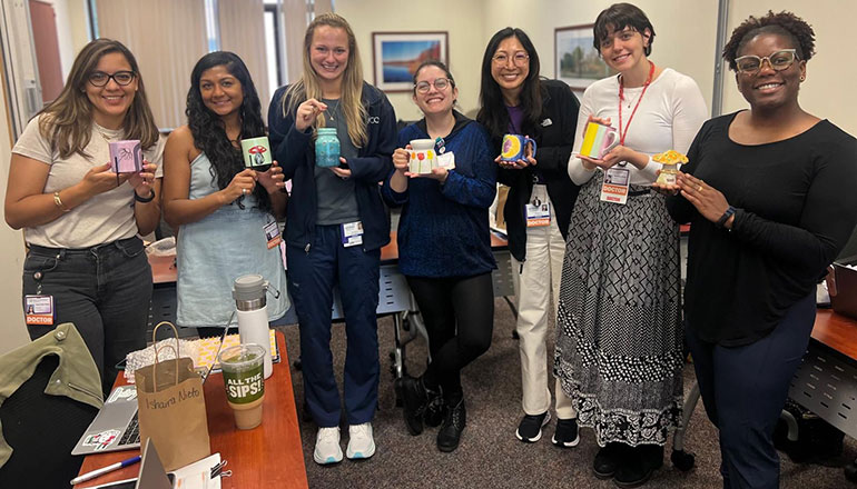Class of 2028 holding pottery