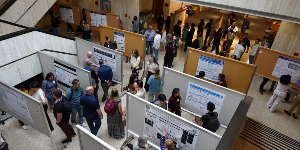 overhead indoor picture of a poster session in a large open lobby area