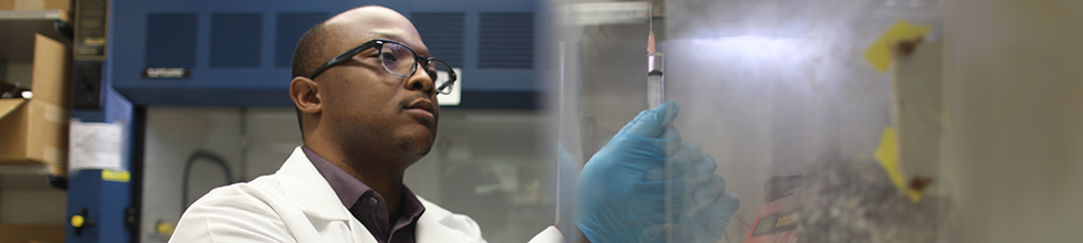 Researcher looking at a test tube