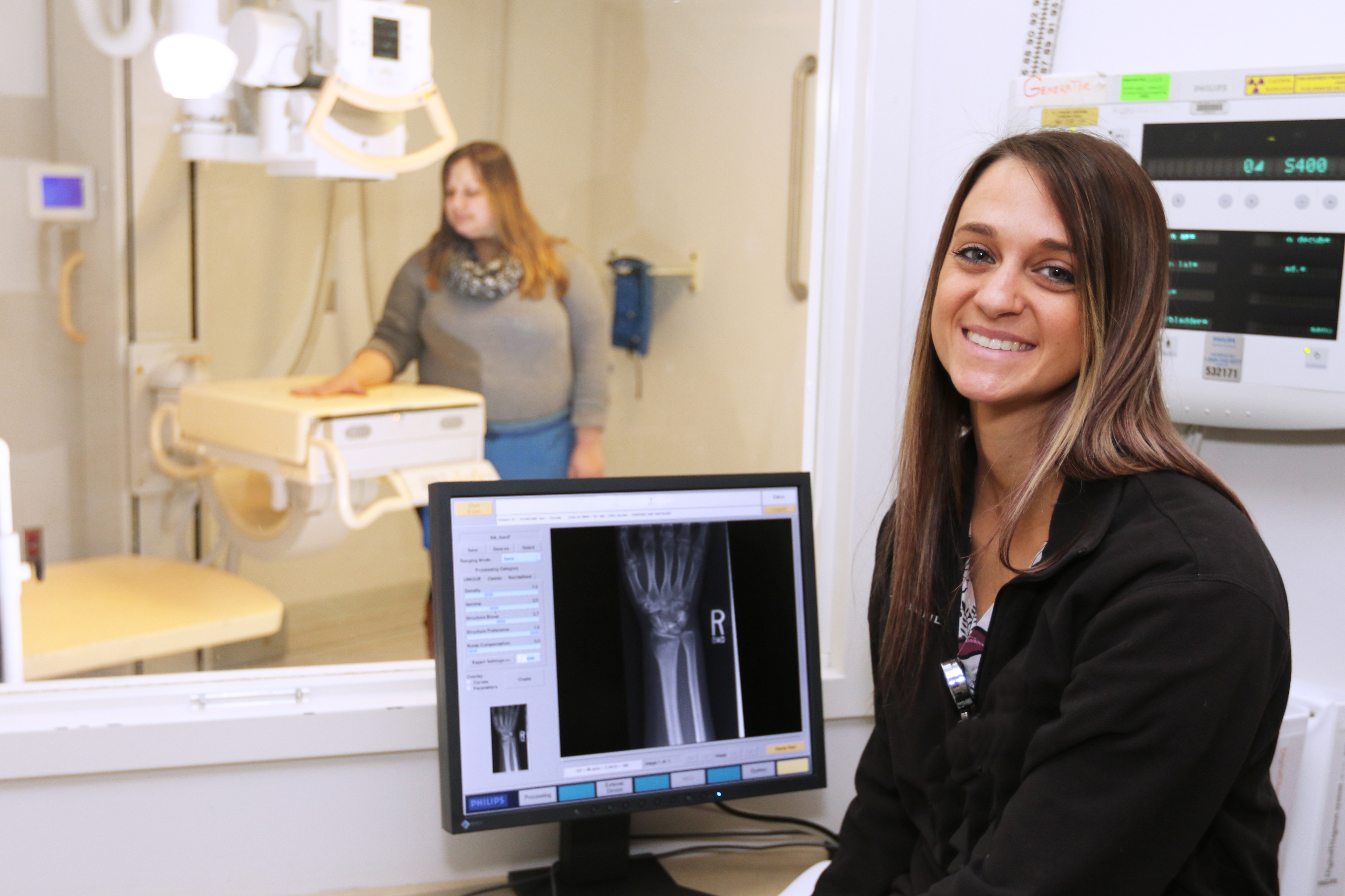 A UConn Health radiology technologist performing an xray on a patient