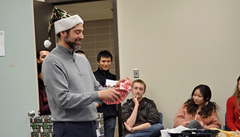 Anthony Vella, Ph.D., opening a gift