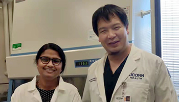 Dr. Sunitha Pulikko standing next to Dr. Zhichao Fan in the lab