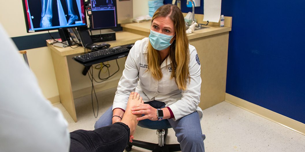 Lauren Geaney MD, a foot and ankle surgeon, examines a patient's ankle