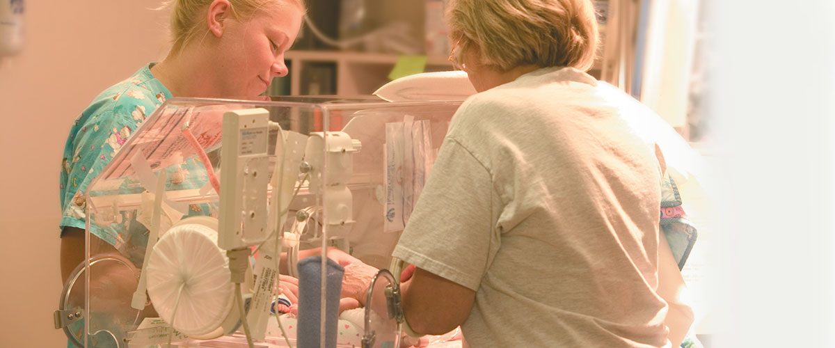 Nursing staff cares for NICU baby 