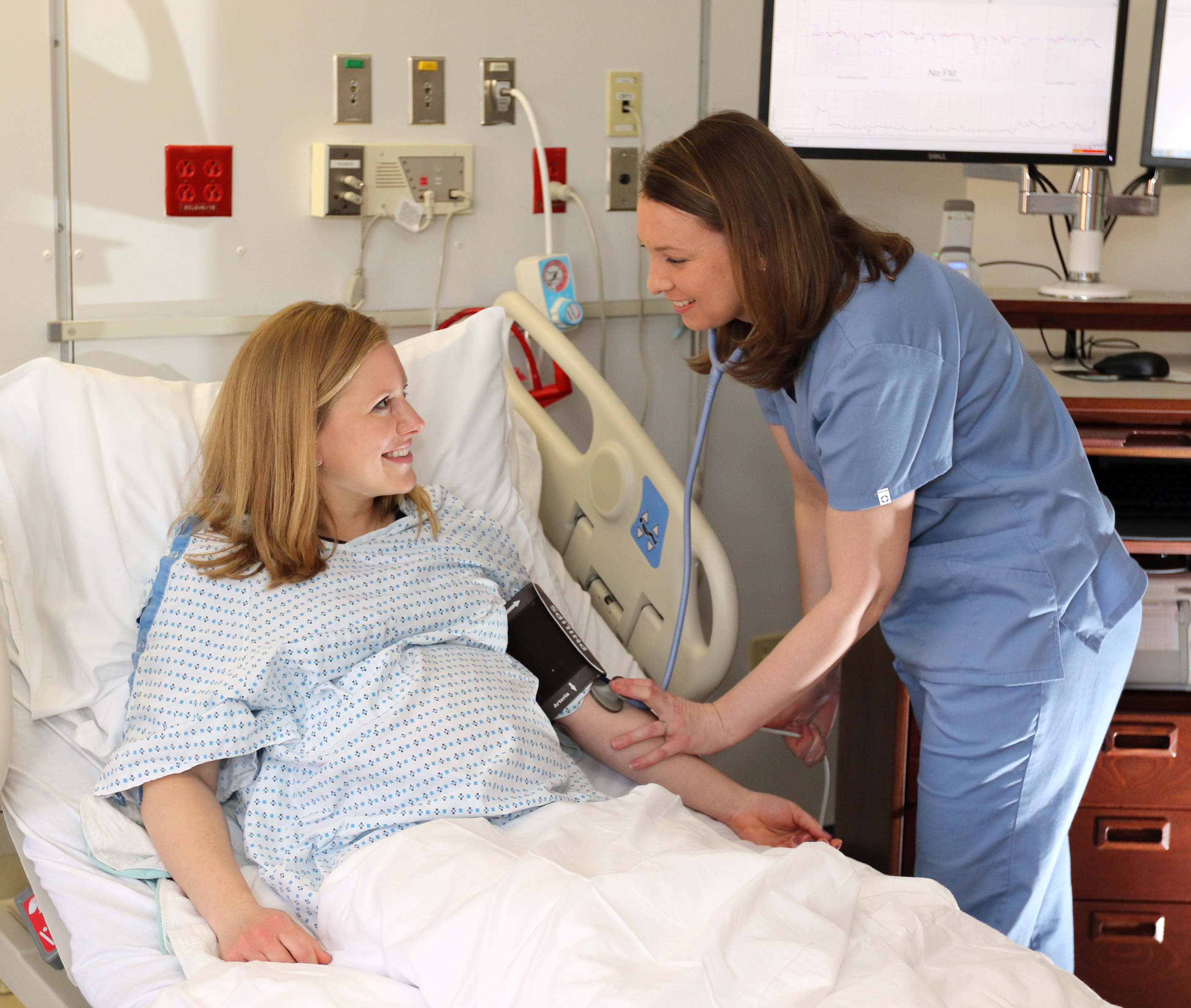 A nurse checks in on a patient in maternity care at UConn John Dempsey Hospital in Farmington