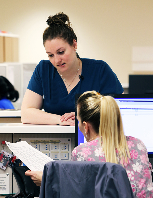 Two nurses talking in the Carole and Ray Neag Comprehensive Cancer Center