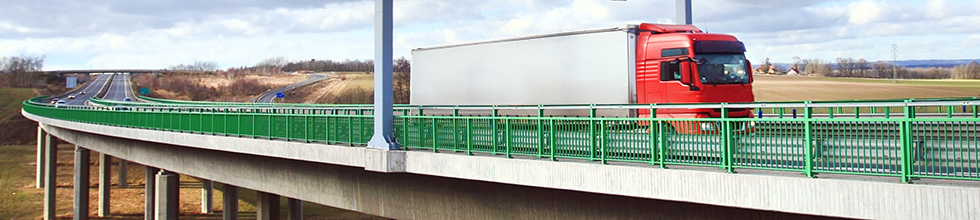 Commercial truck driving on a highway bridge