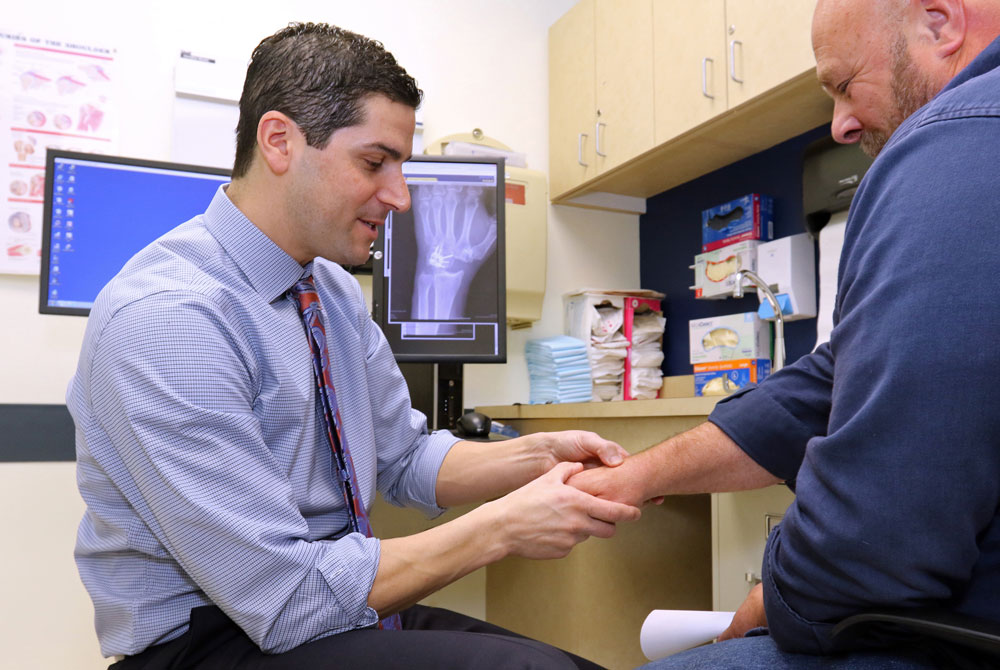 Final-UCONN-2_6_2018_SG_8S6A7890-edit-(1) Craig M. Rodner, M.D. with patient