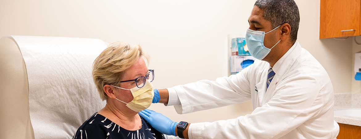 Neurologist Bernardo Rodrigues M.D., Ph.D., getting ready to administer an injection to a patient