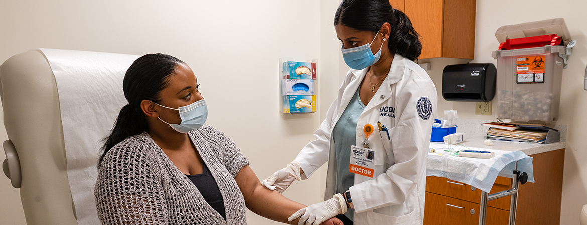 Neurologist Chindhuri Selvadurai, M.D., prepares a patient to receive an injection of botulinum toxin