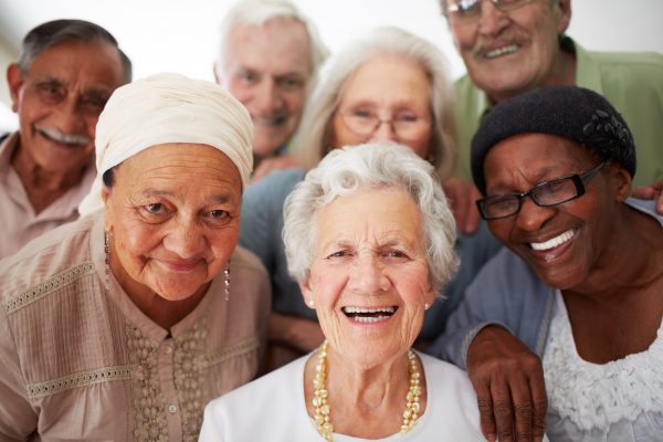 Diverse Group of Senior Citizens Gathering Together and Smiling
