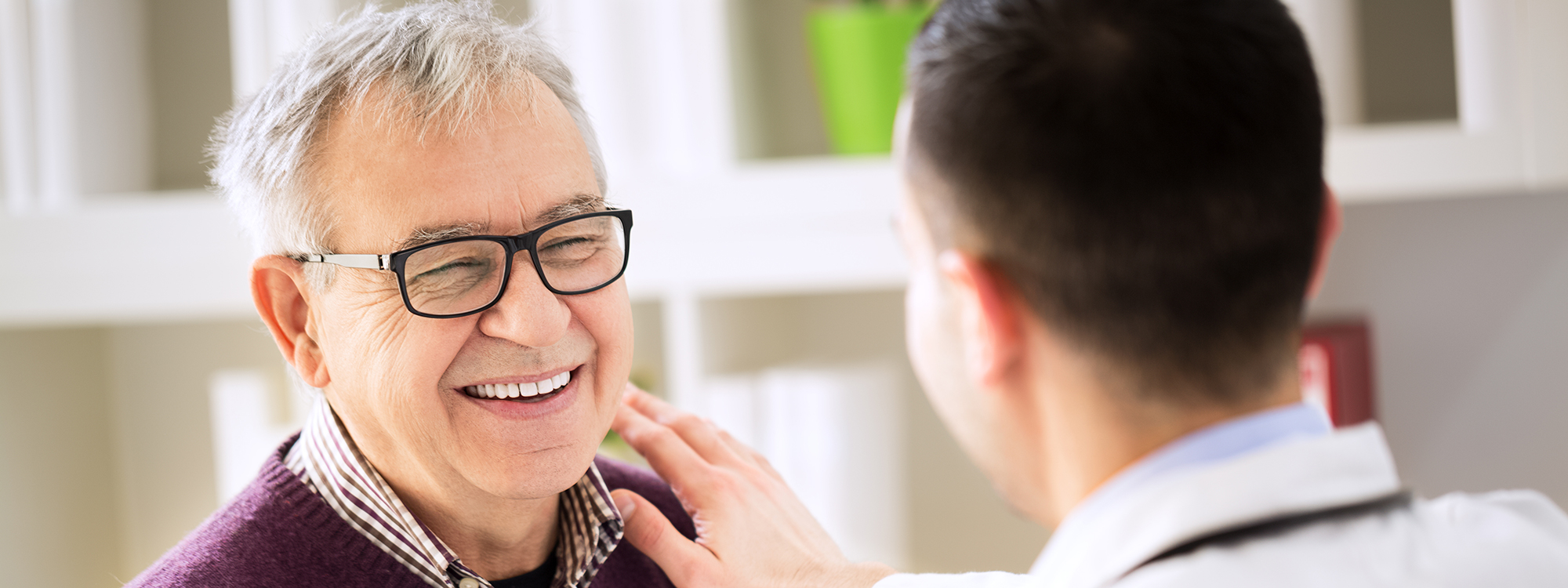 Smiling senior male patient visiting a doctor