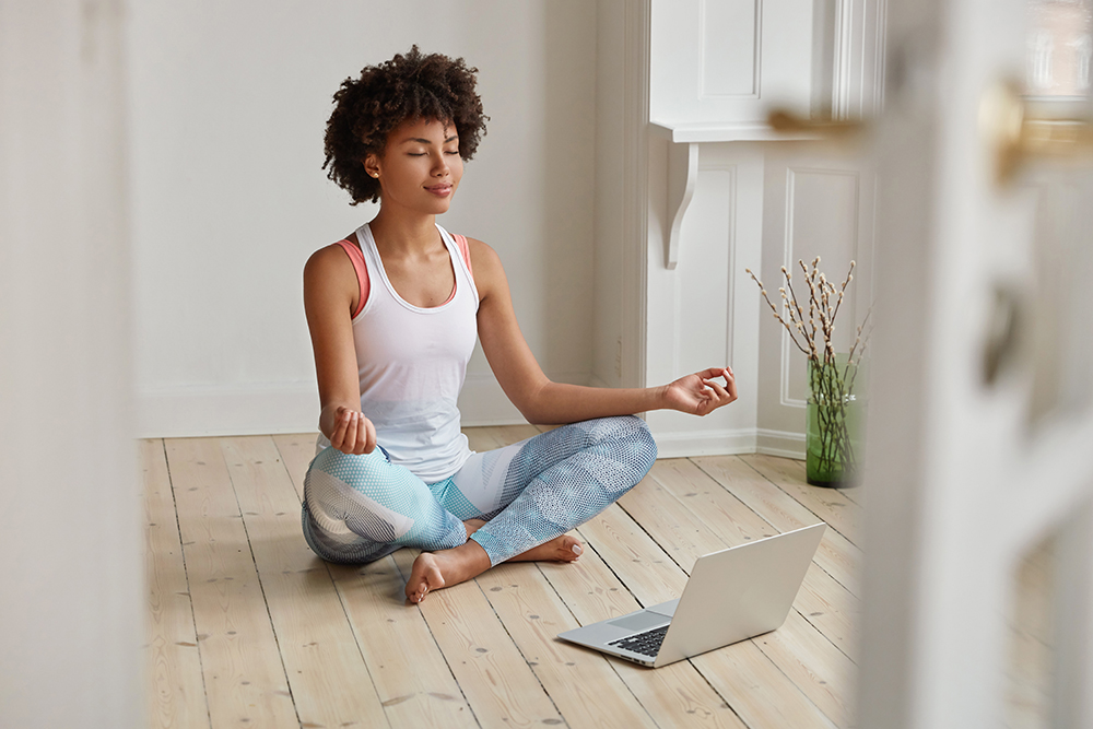 African American woman sitting a floor meditating