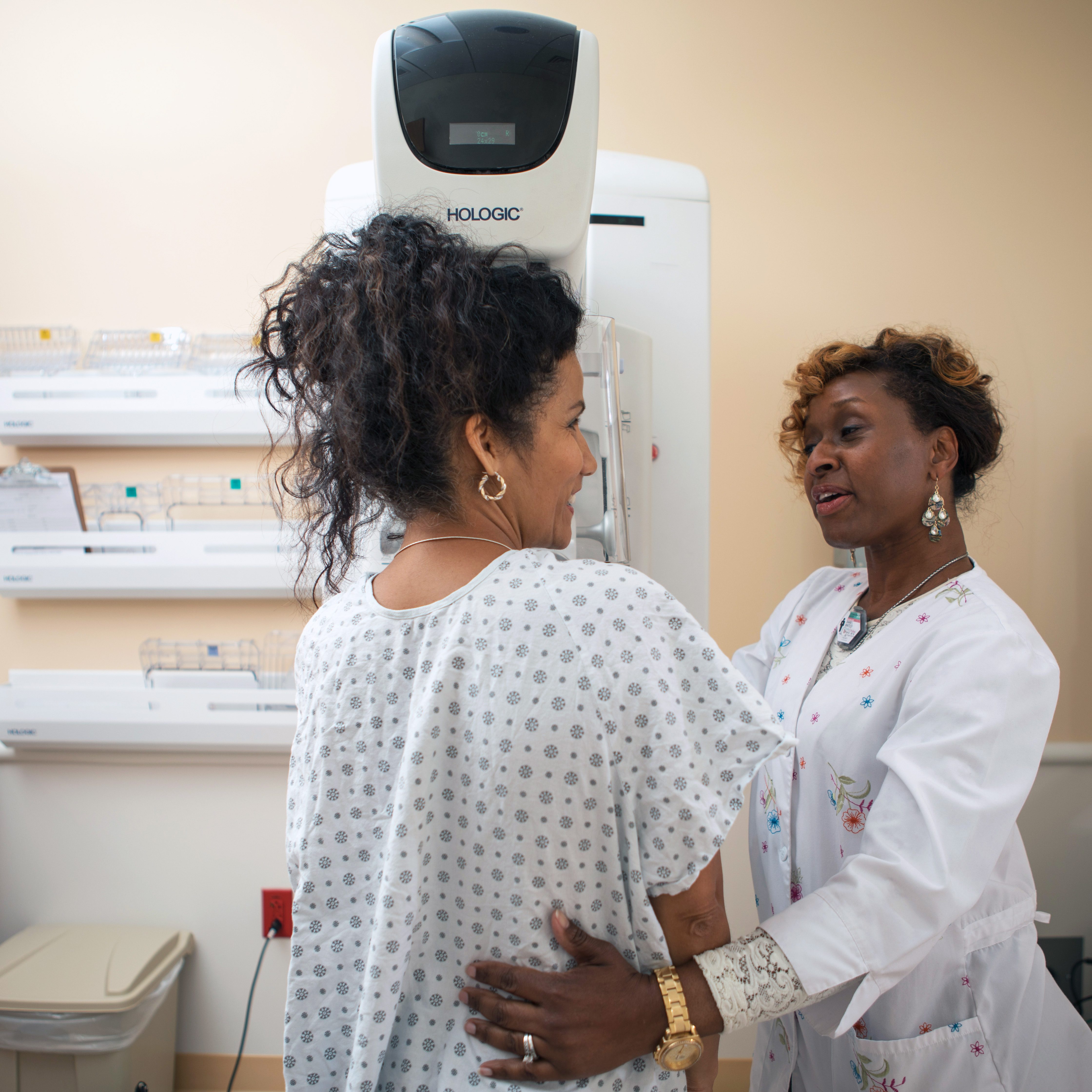 Patient being assisted by a nurse during a mammogram.
