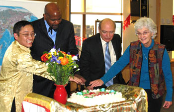Cutting the cake at the Chinese New Year celebration are: (left to right) Ren-He Xu, Cato T. Laurencin, Marc Lalande and Carolyn Lyle