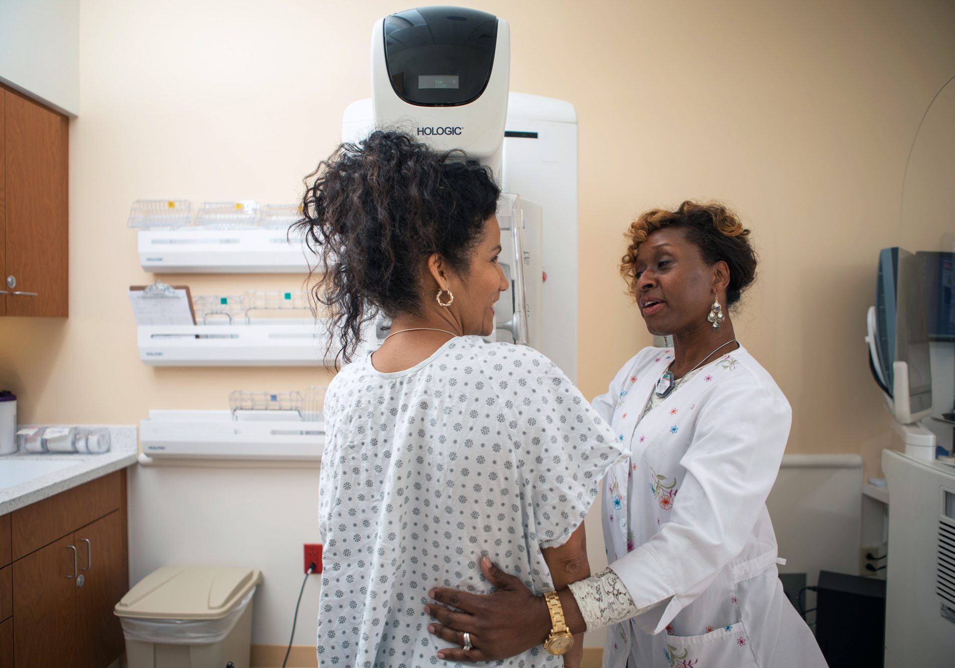 Patient being assisted by a nurse during a mammogram