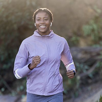 African American woman jogging outside