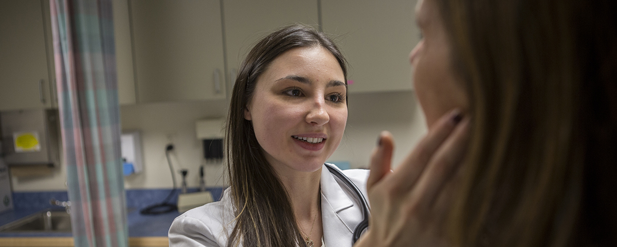 A doctor examining her patient on Dec. 9, 2015. (Paul Horton/UConn Photo)