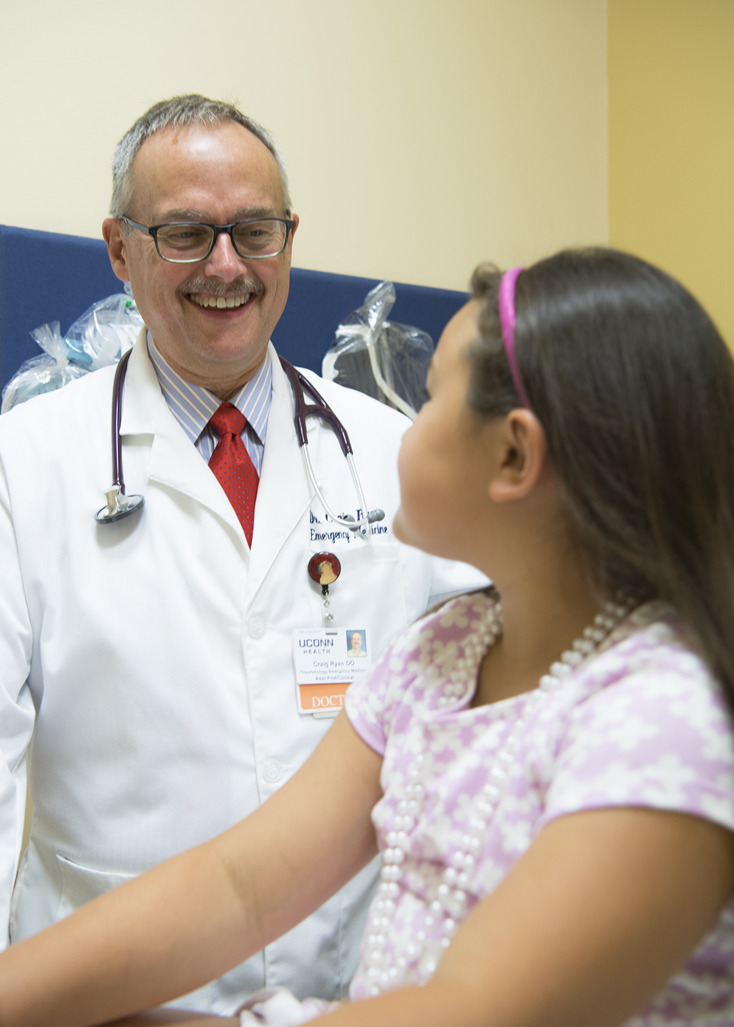 Craig Ryan D.O. meets with a model patient in an examination room at UConn Health Urgent Care in Storrs on Aug. 2, 2017. (Peter Morenus/UConn Photo)