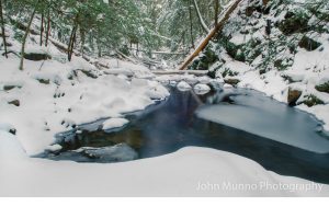 Snow melting into a stream in Southbury, CT (John Munno Photography)