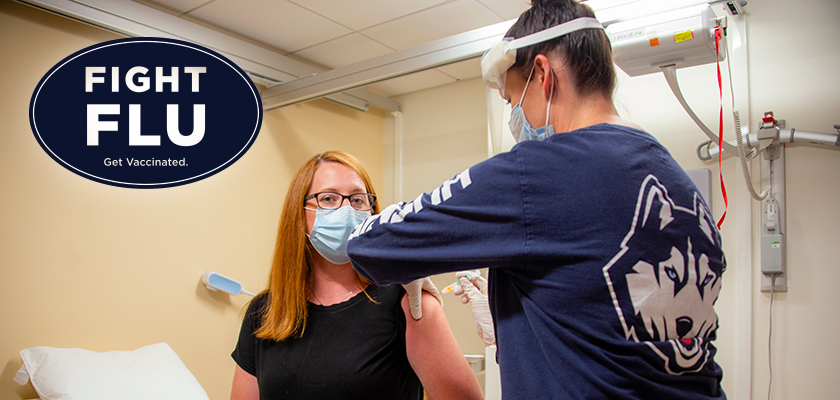 Patient receiving a flu shot in an exam room