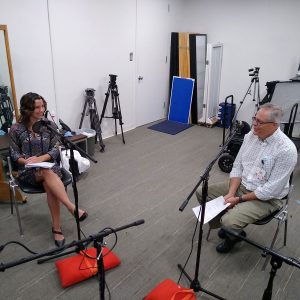 Tia Kozar and Dr. Steffens at microphones in podcast studio