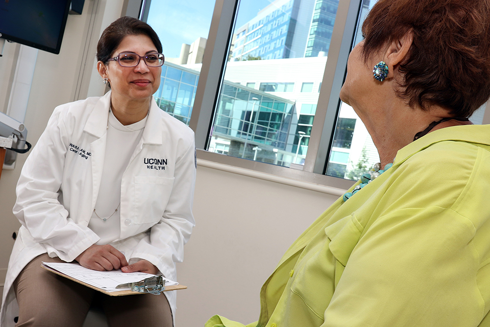 Wahila Alam, M.D., meets with a patient in the UConn Center on Aging