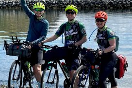 3 cyclists on the shore